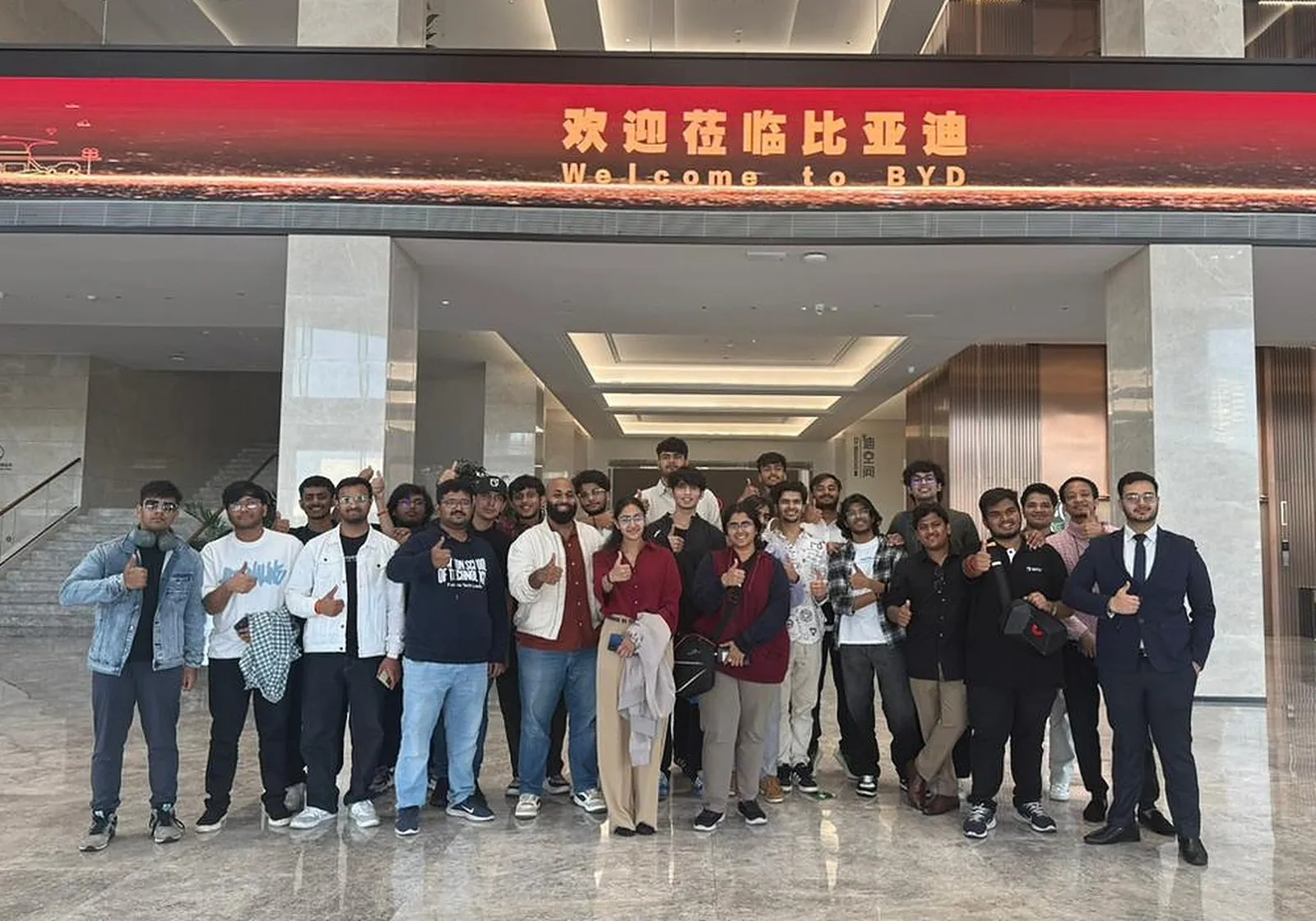 A group of students standing in the lobby of BYD under a Welcome to BYD sign